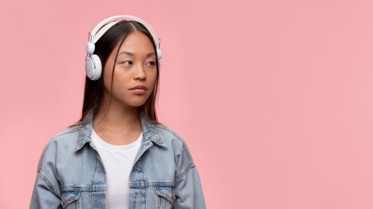 portrait-young-teenage-girl-listening-music-with-her-headphones
