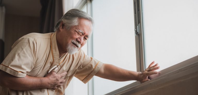 Heart failure and chest pain of male patient during standing after treatment surgery and health check up at hospital