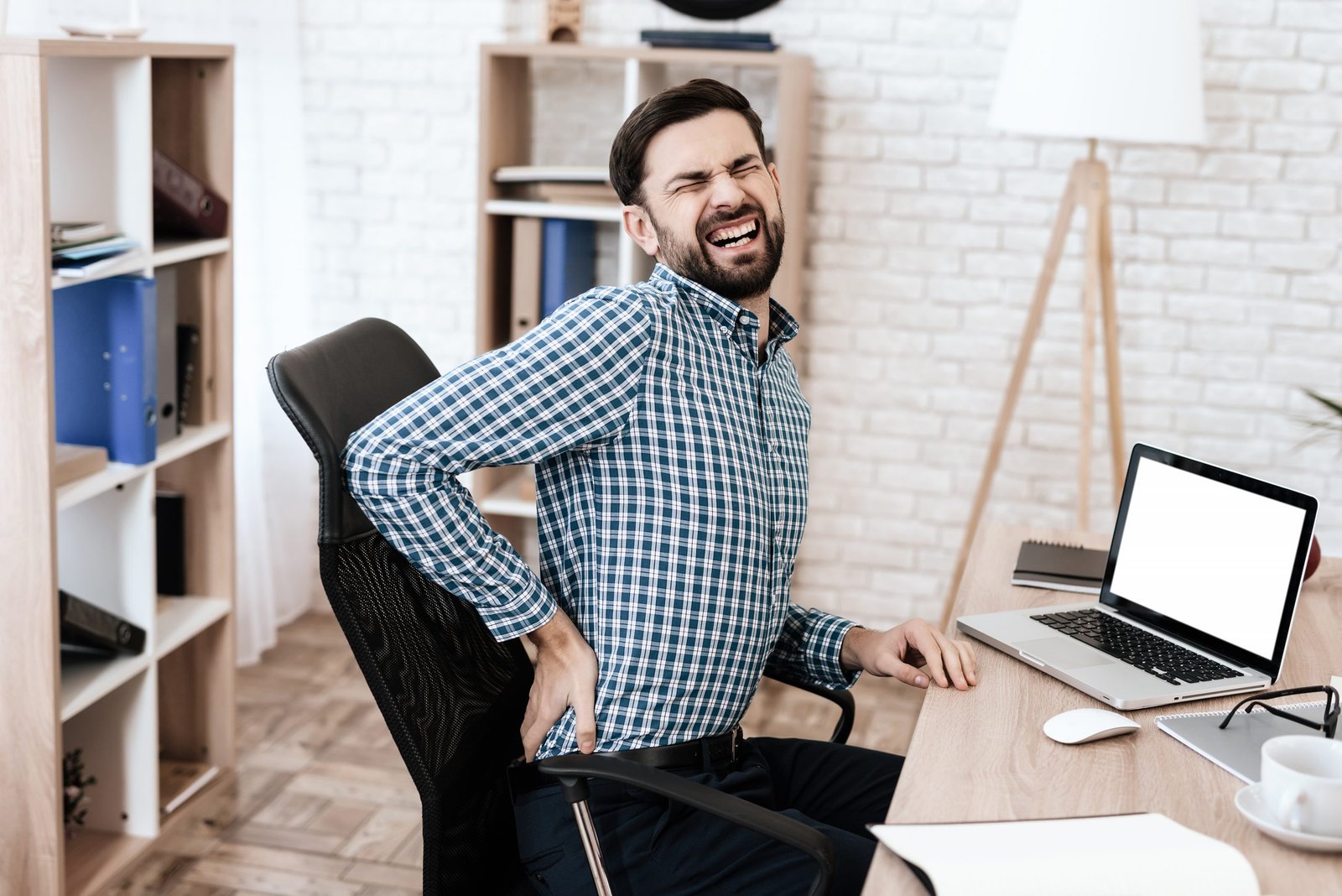 A,Man,In,A,Plaid,Shirt,Sits,At,A,Table