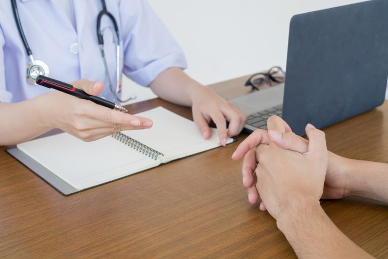 Doctor physician consulting with male patients in hospital exam