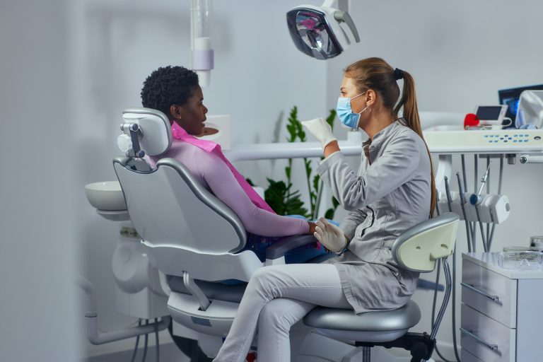 Dentist and african patient at clinic