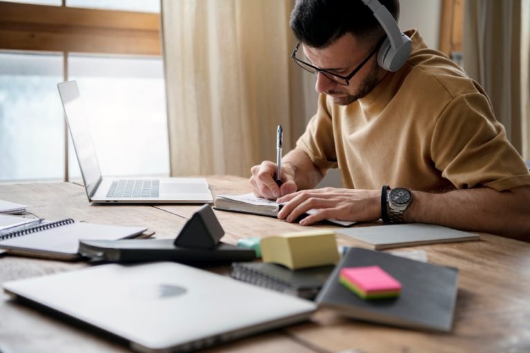 young-man-writing-notebook-during-study-session