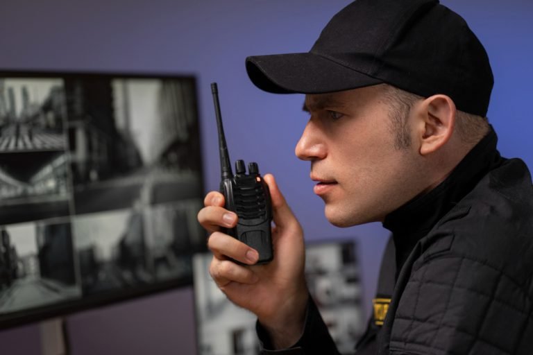portrait-male-security-guard-with-radio-station-camera-screens (1)