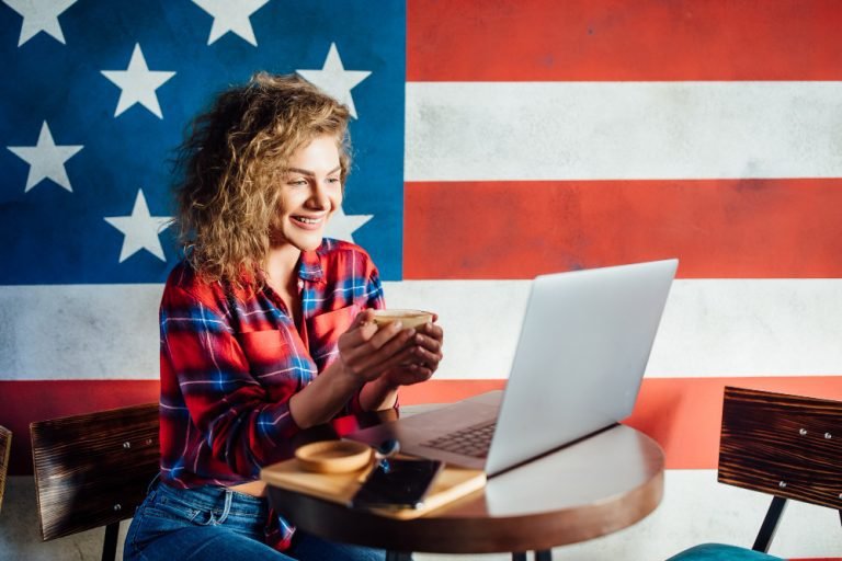 pretty-female-student-with-cute-smile-keyboarding-something-net-book-while-relaxing-after-lectures-university