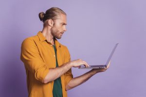 close-up-profile-portrait-guy-with-beard-hold-laptop