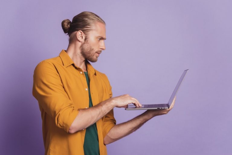 close-up-profile-portrait-guy-with-beard-hold-laptop