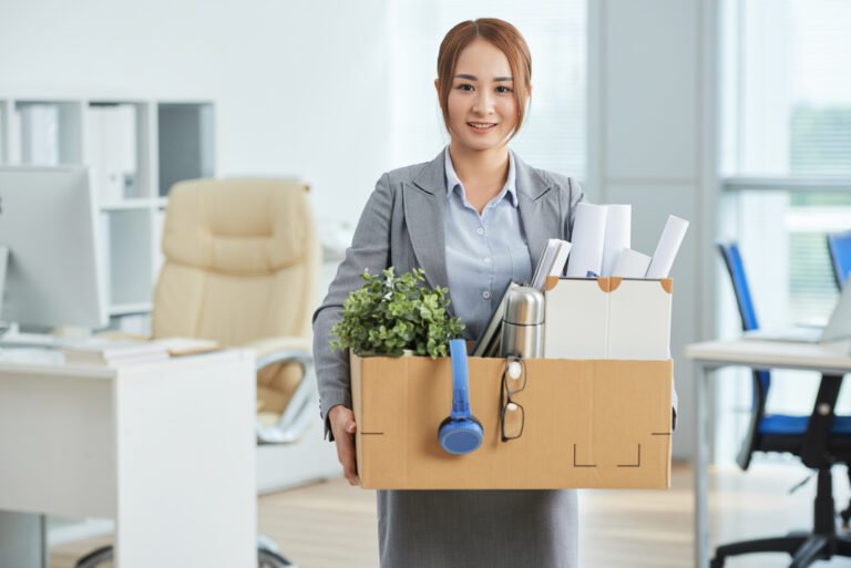 smiling-asian-woman-business-suit-standing-office-with-belongings-cardboard-box