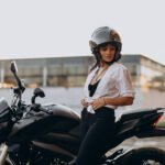 Young sexy female motorcyclist on bike